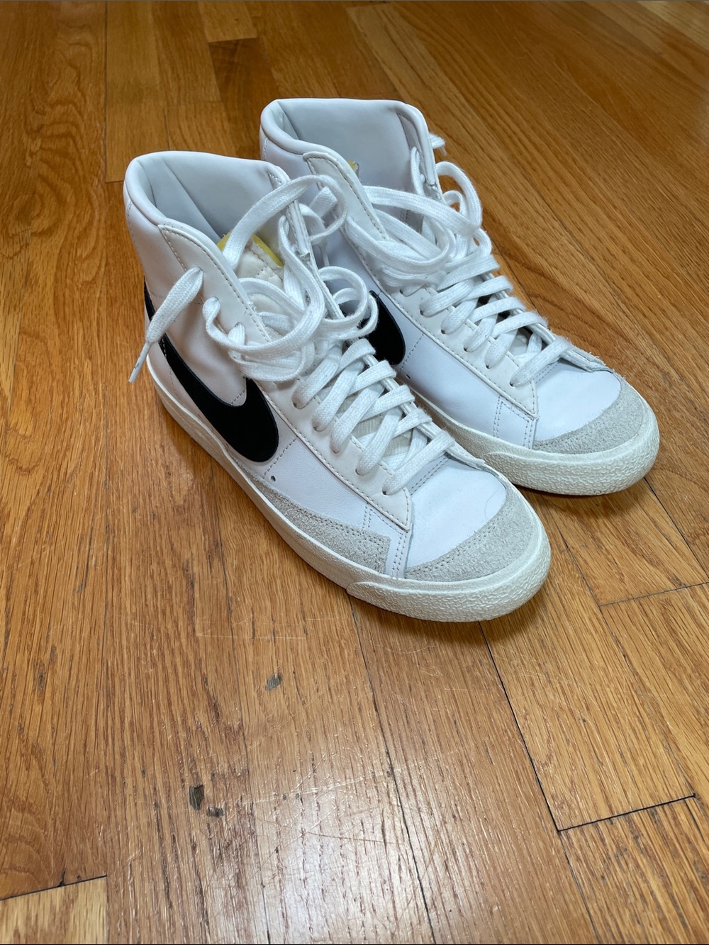 Nike White High-Top Sneakers with Black Swoosh